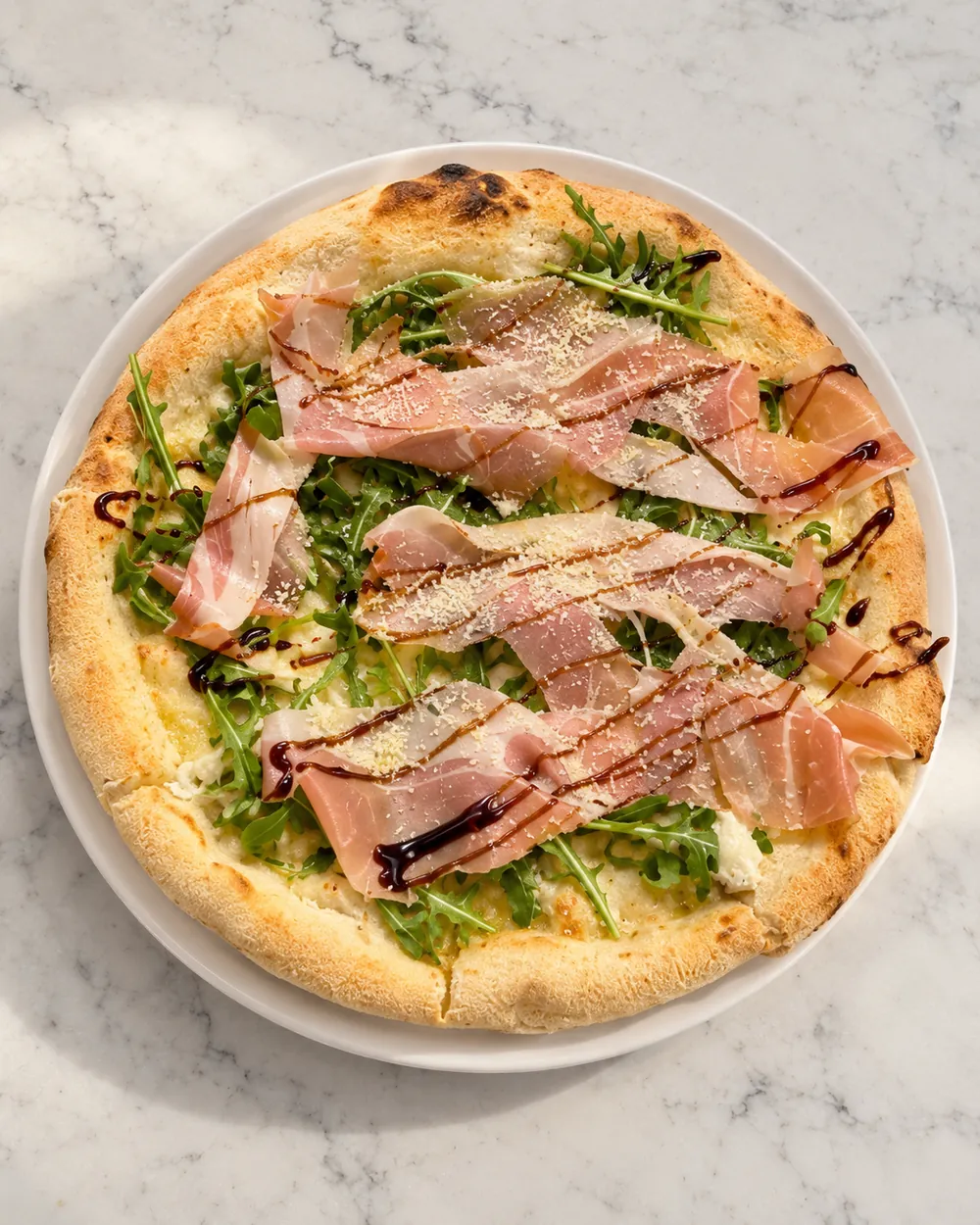 Prosciutto arugula pizza with balsamic